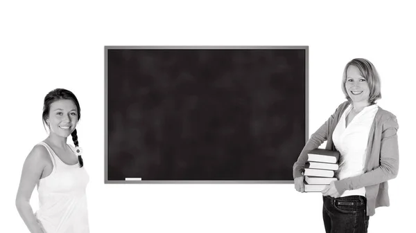 年轻的教师和女学生站在一块空黑板前 被白色背景 黑白照片隔开 — 图库照片
