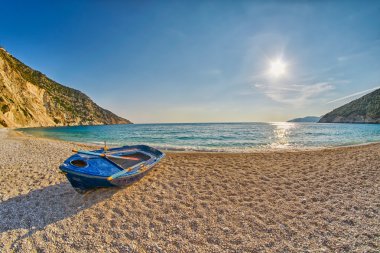 Old Abandoned Fishermen Boat at Sunset Myrtos Beach in Kefalonia, Greece clipart