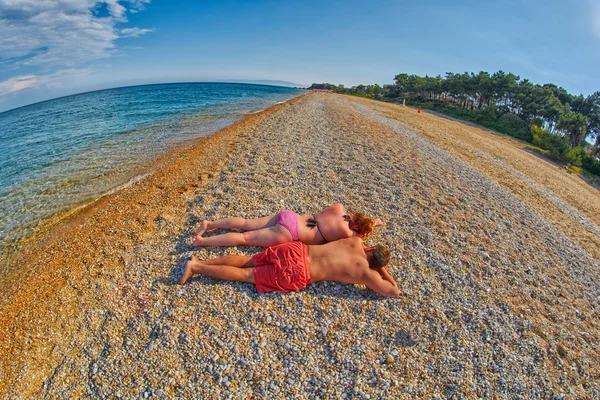 Jovem casal relaxante em uma praia — Fotografia de Stock