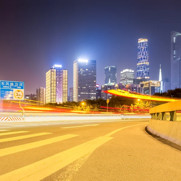 City road with modern buildings at night — Stock Photo, Image