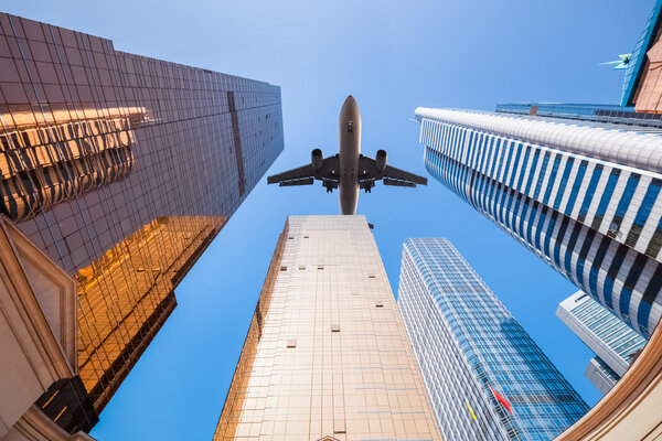 Upward view of airplane and modern building background in guangzhou
