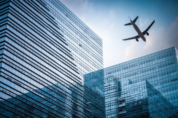 Futuristic building with airplane — Stock Photo, Image