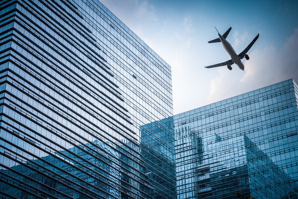 Futuristic glass building with airplane , abstract reflection in the geometry space