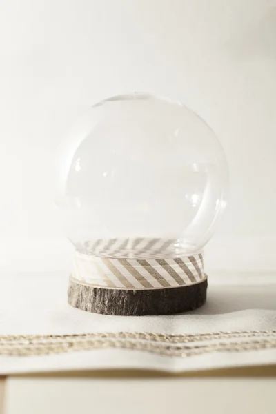 Snow globe on cream background — Stock Photo, Image