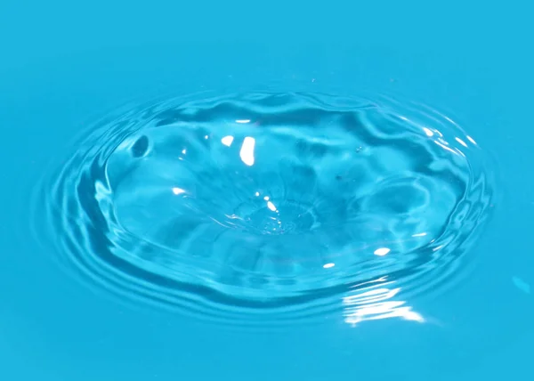 trace on the surface of clean water after impact when a drop of liquid falls