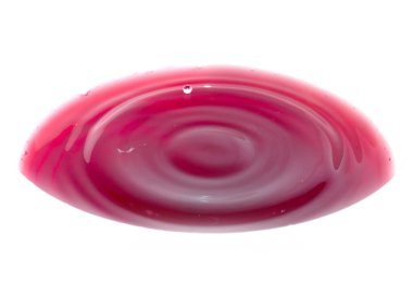 Parlak kırmızı kan damlaları sıvının yüzeyine düşer.