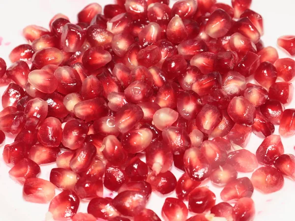 bright red grains of ripe pomegranate as a treat and treat