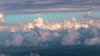 view from the window of the aircraft on the veil of clouds and the surface of the earth