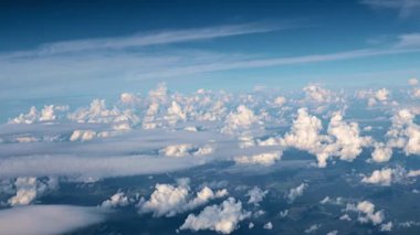 view from the window of the aircraft on the veil of clouds and the surface of the earth