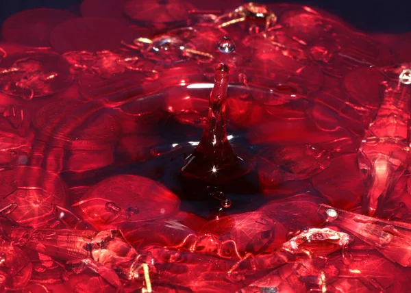 Uma Gota Líquido Vermelho Cai Superfície Água Monte Rublos Metálicos — Fotografia de Stock