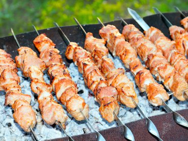 Izgaradaki şişte kızarmış et pişirme işlemi.