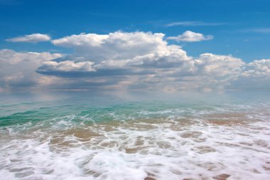 beautiful landscape with pebble beach and waves of the sea against the backdrop of a cloudy sky