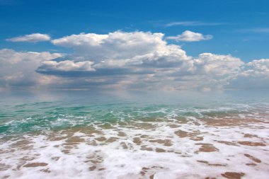 beautiful landscape with pebble beach and waves of the sea against the backdrop of a cloudy sky