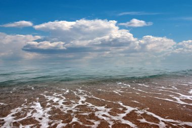 Güzel kumlu sahil ve bulutlu yaz gökyüzü