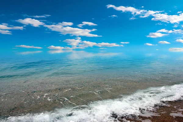 sea beach under sunny summer sky with clouds