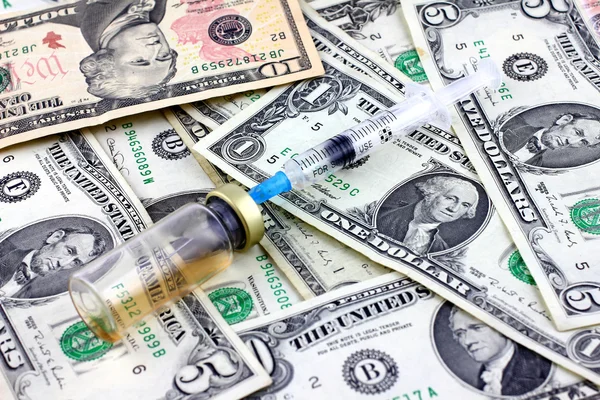 Syringe, ampoule and dollars — Stock Photo, Image