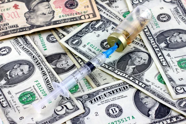 Syringe, ampoule and dollars — Stock Photo, Image