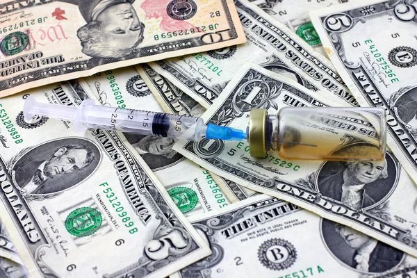 Syringe, ampoule and dollars — Stock Photo, Image