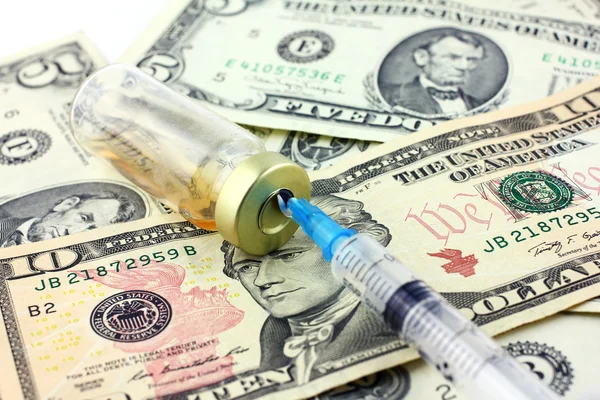 Syringe, ampoule and dollars — Stock Photo, Image