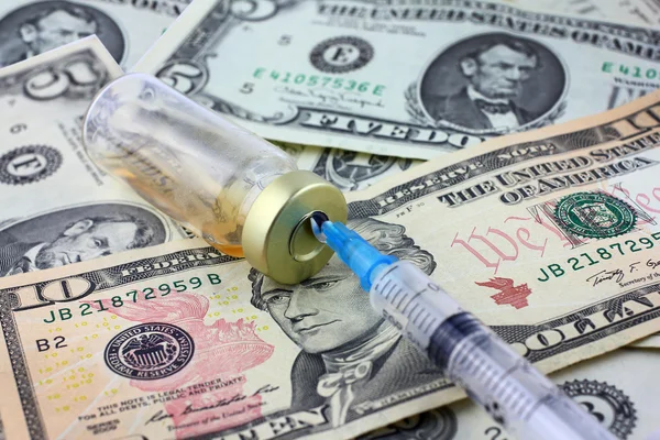 Syringe, ampoule and dollars — Stock Photo, Image