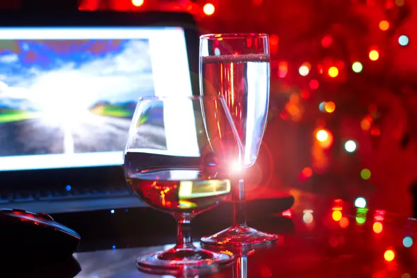 Laptop and glass goblets — Stock Photo, Image