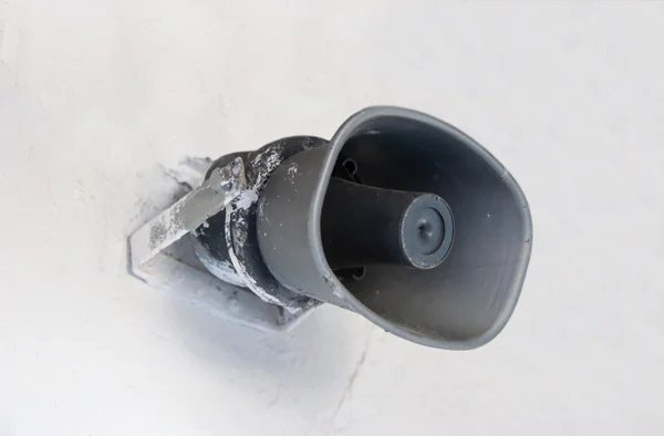 Grey loudspeaker on a white wall — Stock Photo, Image