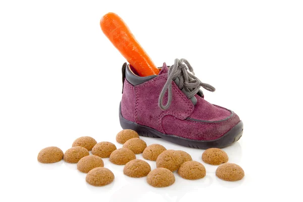 Zapatilla infantil morada con zanahoria y pepernoten (ginge —  Fotos de Stock