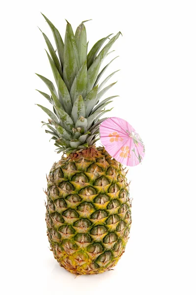 Tropical pineapple with pink umbrella — Stock Photo, Image