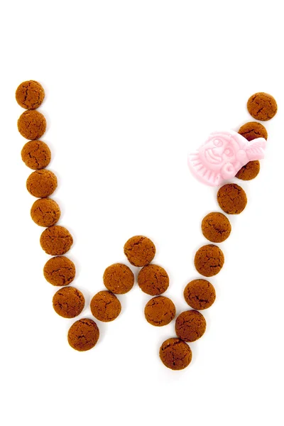 Ginger nuts, pepernoten, in the shape of letter W isolated on wh — Stock Photo, Image