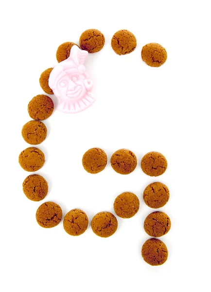 Ginger nuts, pepernoten, in the shape of letter g isolated on wh — Stock Photo, Image