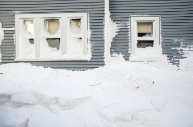 Snow mount piled under residential windows clipart
