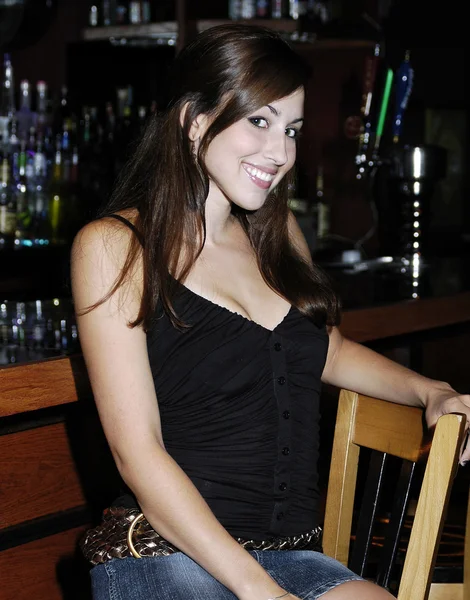 Smiling Brunette sitting at Bar — Stock Photo, Image