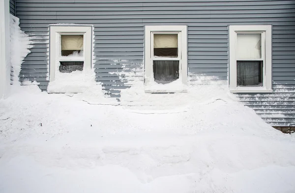 Snow mound under three windows — Stock Photo, Image