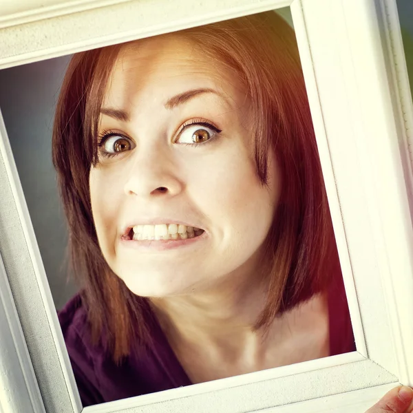 Woman framed by photo frame — Stock Photo, Image