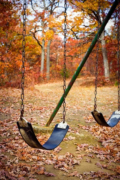 Old swingset at a park in the fall — Stock Photo, Image