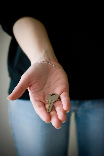 Woman holding and showing key — Stock Photo, Image