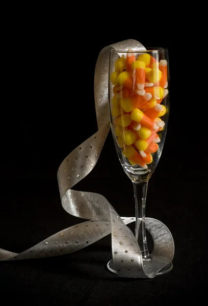 Candy corn in champagne glas — Stockfoto