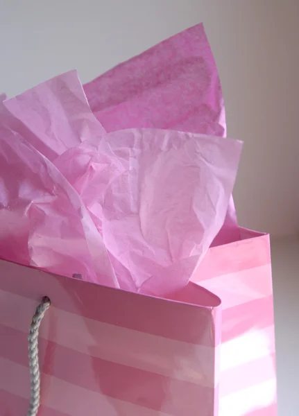 Pink shopping bag with tissue paper — Stock Photo, Image