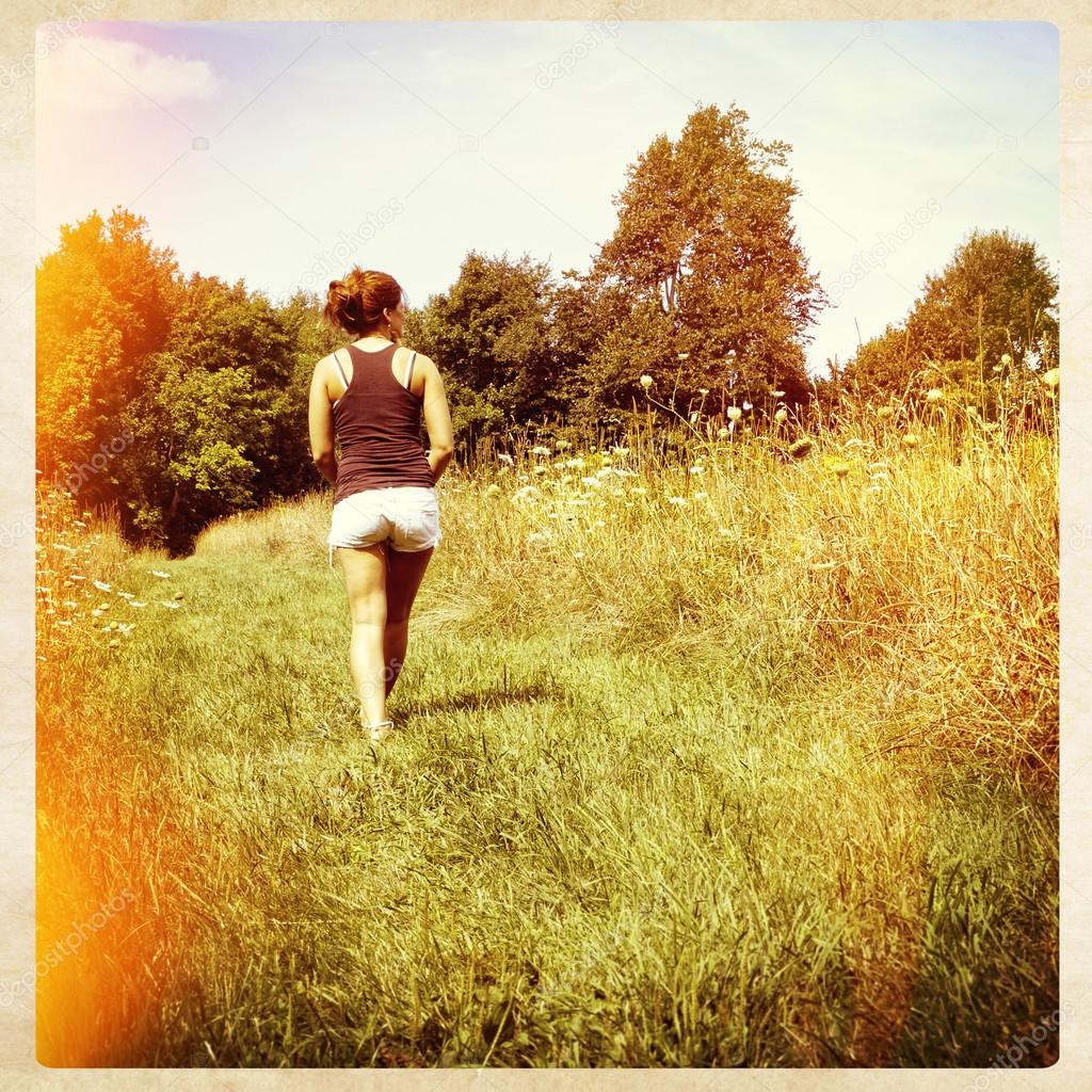 Woman walking away in nature