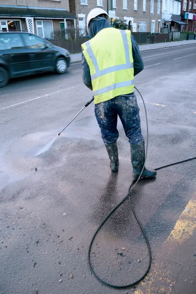 Washing street with hose — Stock Photo, Image