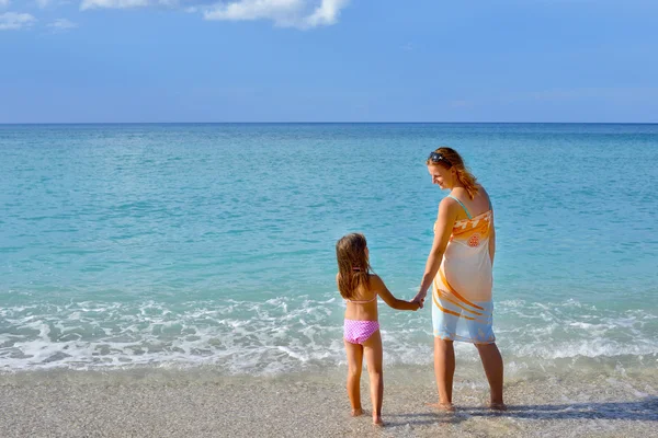 Bedårande barn girl njuter av sin semester på stranden med — Stockfoto