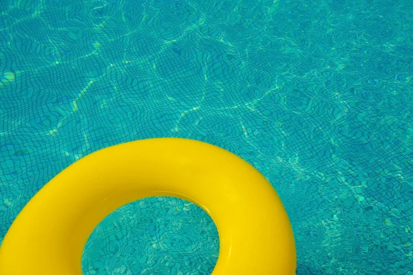 Colorful inflatable tube floating in a swimming pool, summer vacation concept