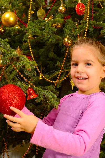 Adorable toddler girl holding decorative Christmas toy ball Stock Photo