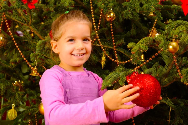 Adorable toddler girl holding decorative Christmas toy ball — Stock Photo, Image