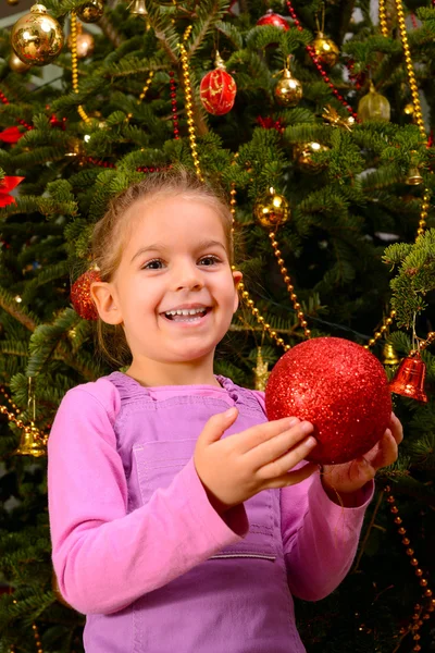 Adorable toddler girl holding decorative Christmas toy ball — Stock Photo, Image