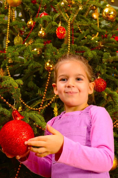 Adorable toddler girl holding decorative Christmas toy ball — Stock Photo, Image