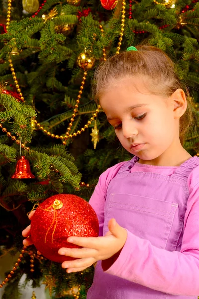 Adorable toddler girl holding decorative Christmas toy ball — Stock Photo, Image