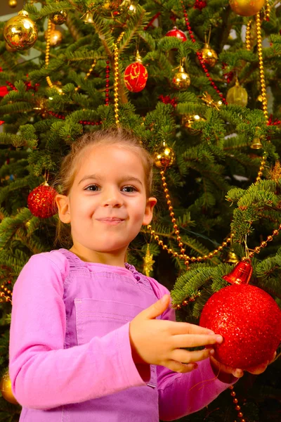 Adorable toddler girl holding decorative Christmas toy ball — Stock Photo, Image