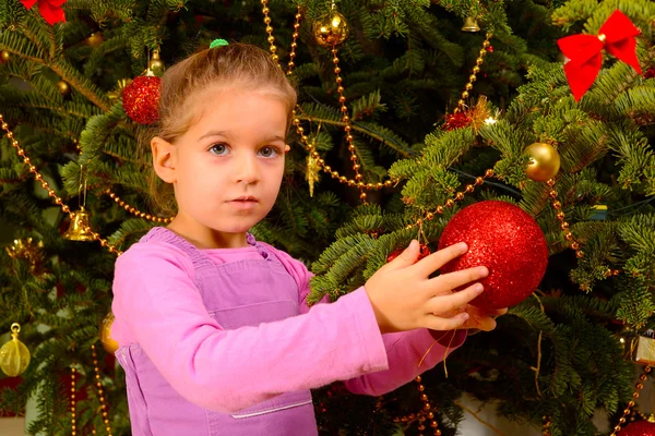 Adorable toddler girl holding decorative Christmas toy ball — Stock Photo, Image