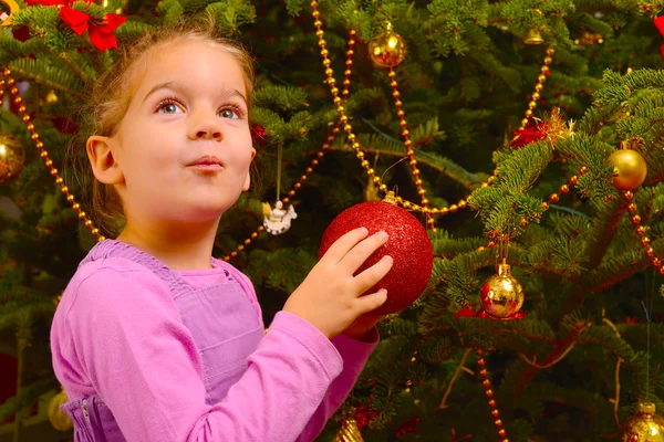 Adorable toddler girl holding decorative Christmas toy ball — Stock Photo, Image